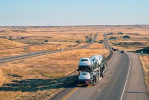 Truck loaded with cars driving through I-80