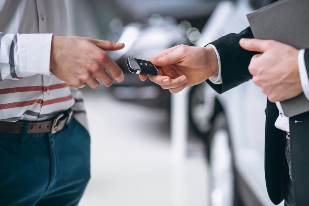 Close-up of male hands exchanging a car key