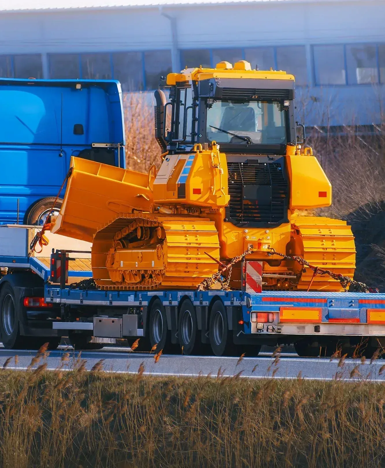 An excavator being transported on a flatbed trailer