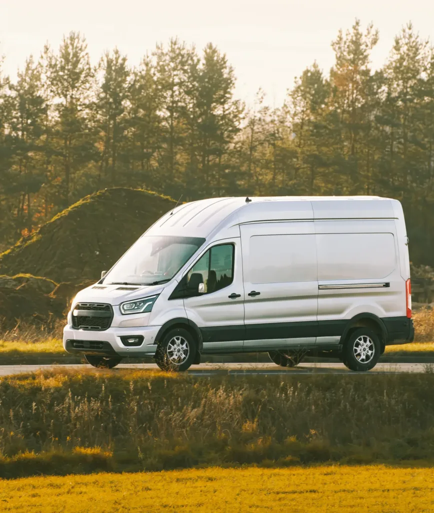 White delivery van driving on countryside road