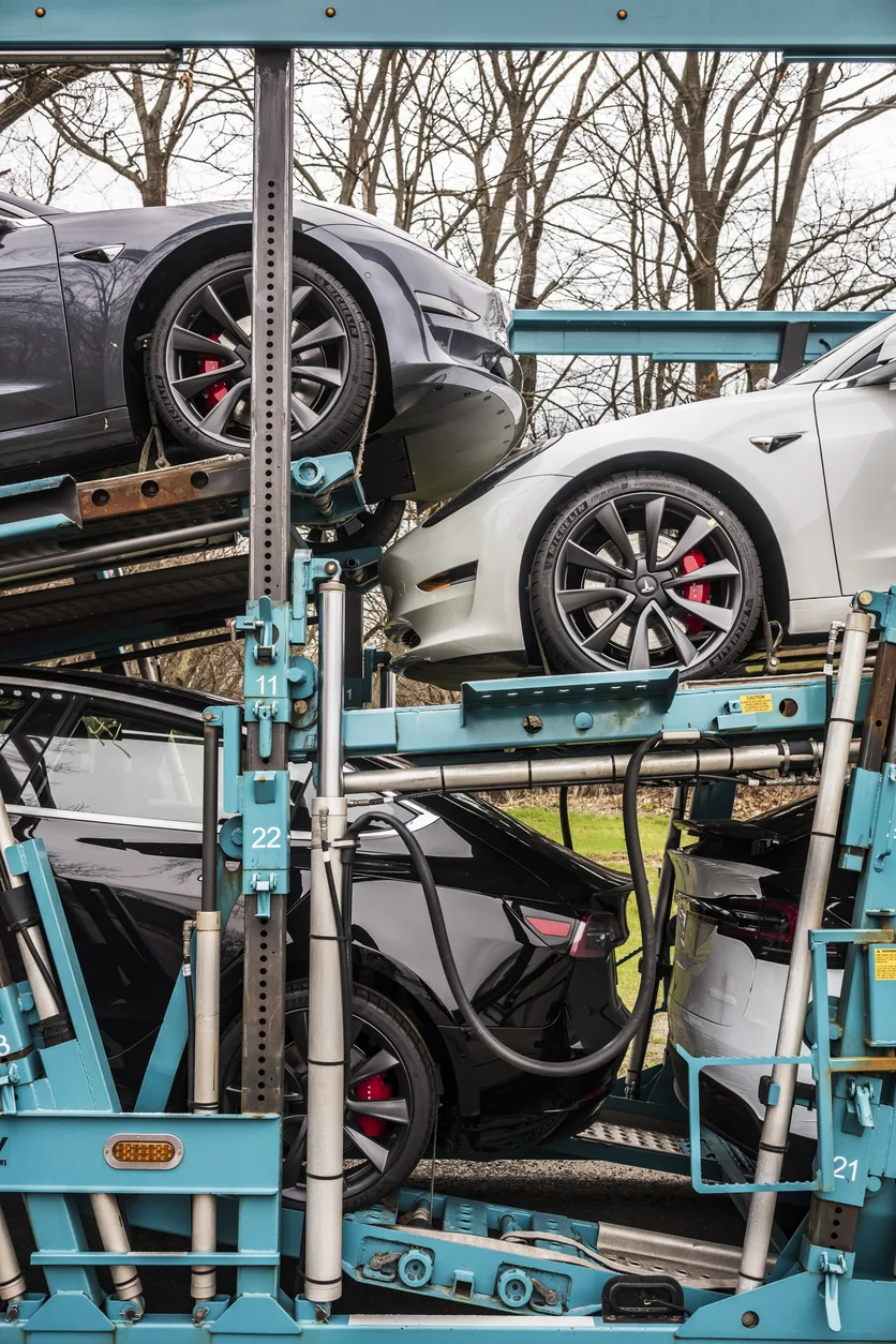 Seven Tesla Model 3s and Xs on a truck