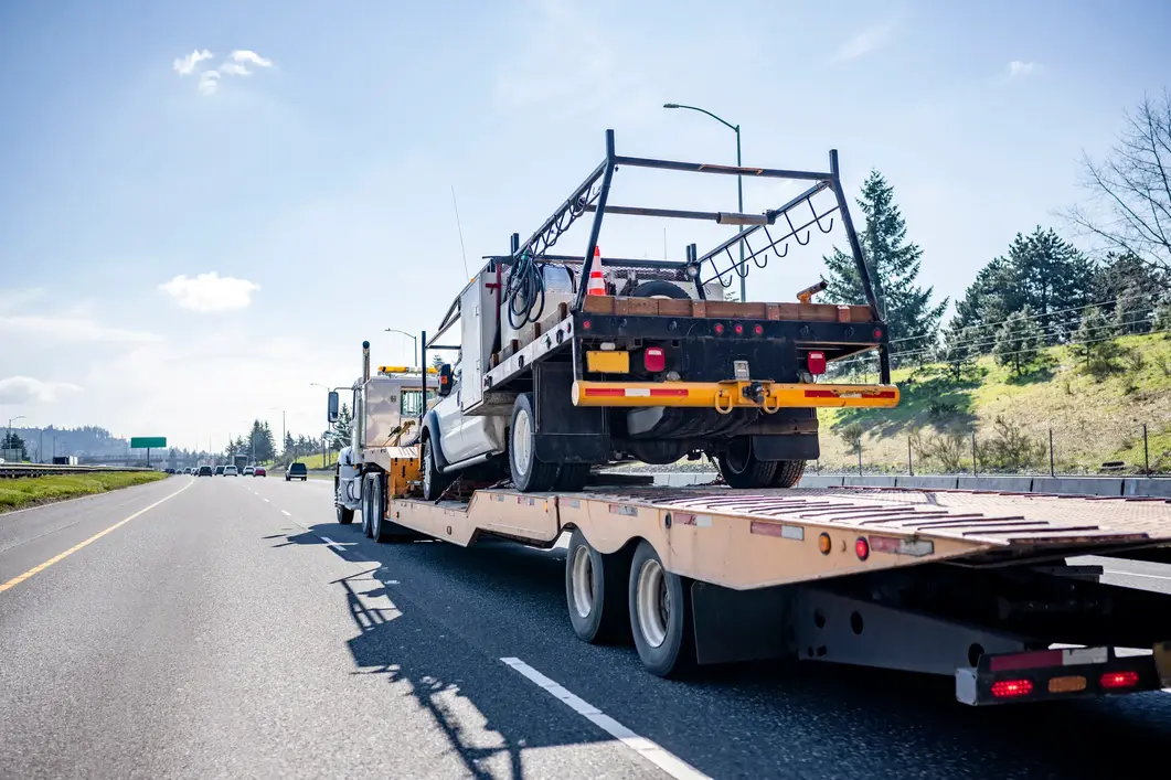 Flatbed Hotshot Truck Moving a Service Vehicle