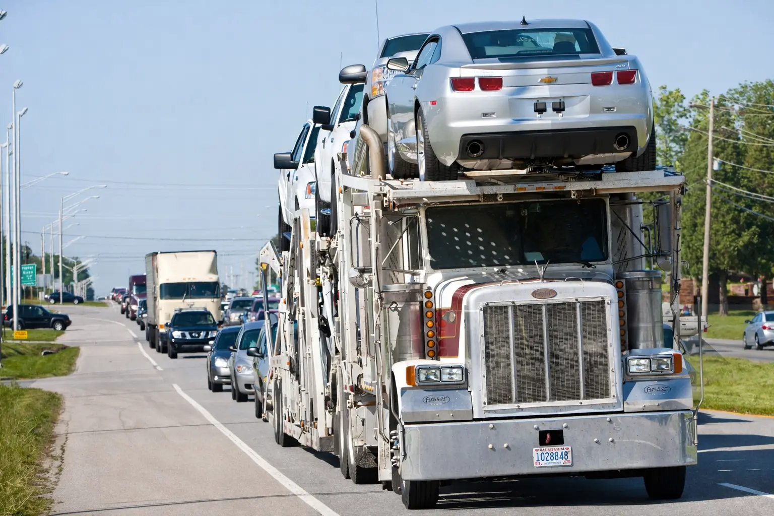 Truck Loaded with Cars on a Busy Highway